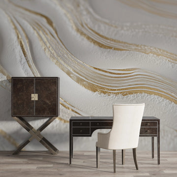 Stylish interior featuring a marble wave wallpaper with gold accents and modern desk and chair.
