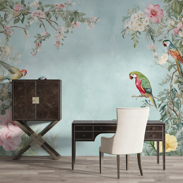 Colorful parrot wallpaper in a chic office setting with floral accents and modern furniture.