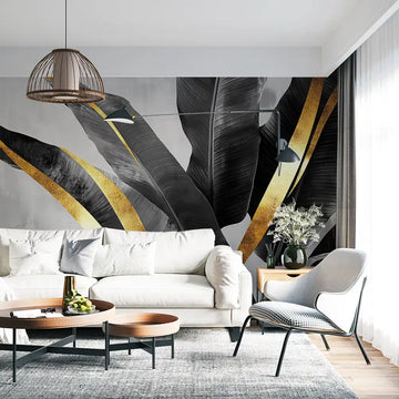 Elegant wall mural with dark leaves and gold accents in a stylish living room setting.