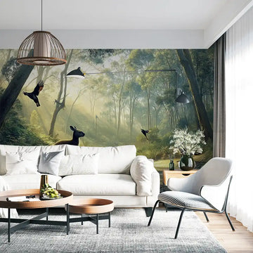 Interior design featuring a forest mural with birds, creating a serene atmosphere in a living room setting.